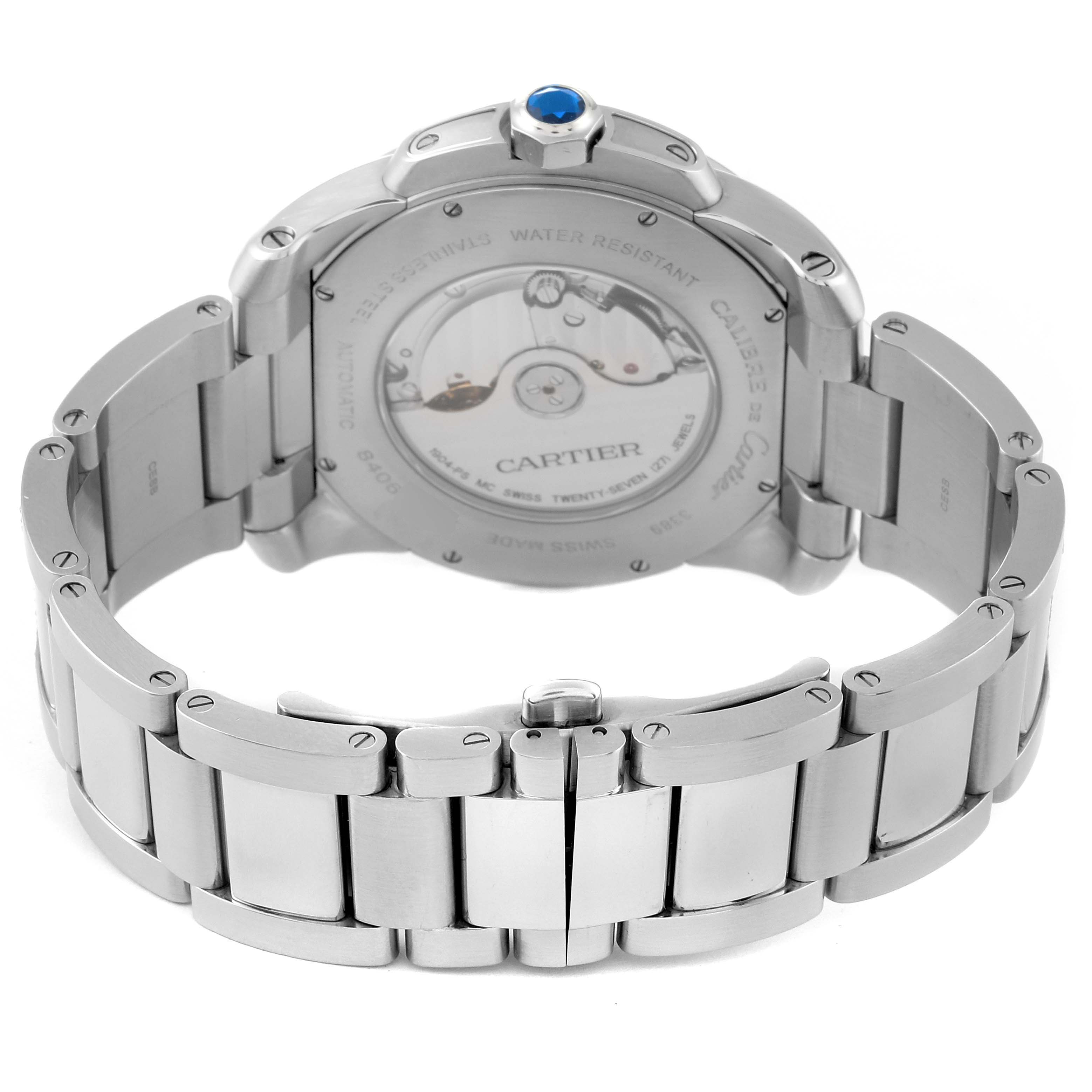 The image shows the back view of a Calibre de Cartier watch by Cartier, highlighting its stainless steel bracelet and the transparent case back.