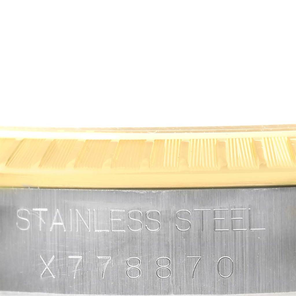 This is a close-up of the stainless steel casing with the serial number on a Rolex Date 15223 Men's Steel and Gold (two tone) White Dial 15223 Men's Steel and Gold (two tone) White Dial model watch.