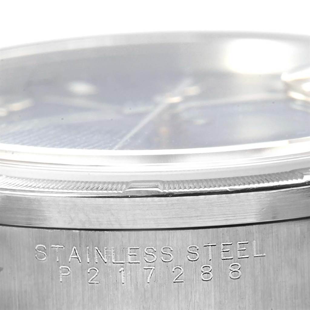 This close-up angle shows the side of a Rolex Date 15210 Men's Stainless Steel Blue Dial 15210 Men's Stainless Steel Blue Dial model watch, highlighting the stainless steel case and serial number.