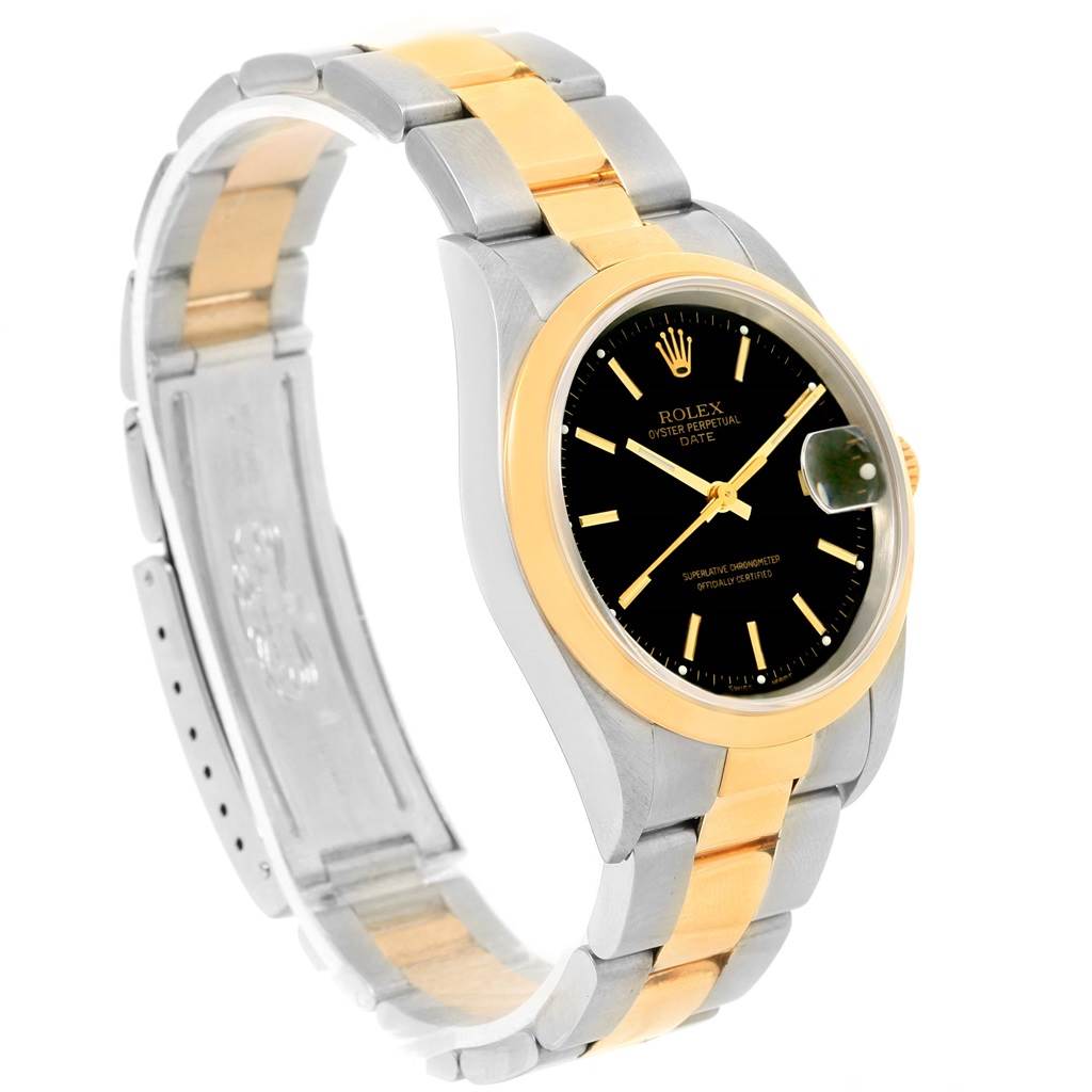 This image shows a side angle of a Rolex Date 15203 Men's Steel and Gold (two tone) Black Dial 15203 Men's Steel and Gold (two tone) Black Dial model watch, highlighting its black dial, gold bezel, and two-tone bracelet.