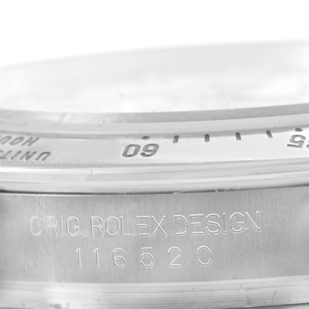 This close-up image shows the side engraving and part of the bezel of the Rolex Daytona 116520 Men's Stainless Steel White Dial 116520 Men's Stainless Steel White Dial watch.