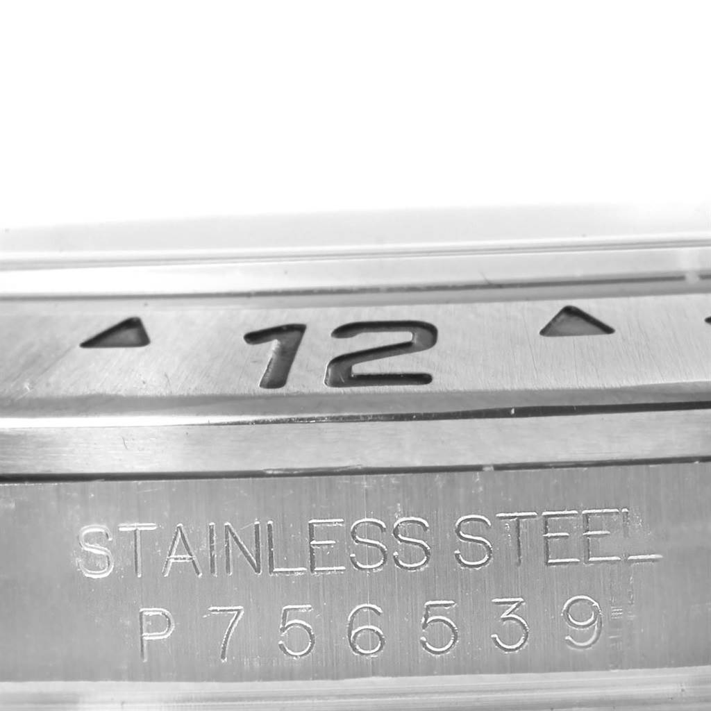 The image shows a close-up of the stainless steel caseback and bezel with the "12" marker of a Rolex Explorer 16570 Men's Stainless Steel Black Dial 16570 Men's Stainless Steel Black Dial watch.