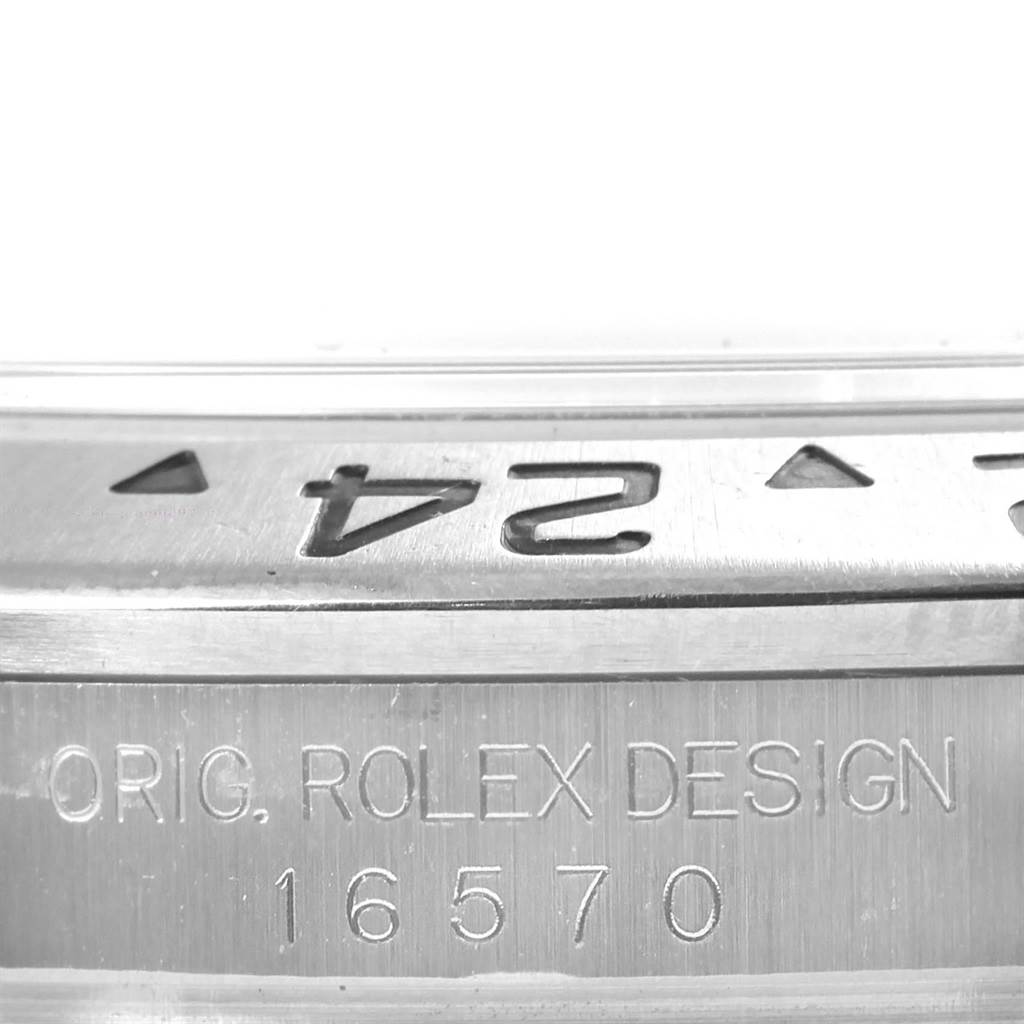 This image shows a close-up of the bezel and engraved serial number of a Rolex Explorer 16570 Men's Stainless Steel Black Dial 16570 Men's Stainless Steel Black Dial model 16570.
