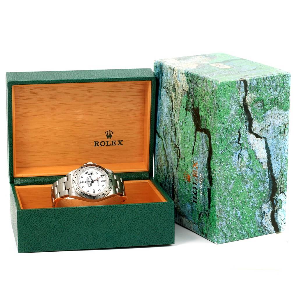 The image shows a Rolex Explorer 16570 Men's Stainless Steel White Dial 16570 Men's Stainless Steel White Dial watch placed in an open green and wooden Rolex box, with the outer box beside it.