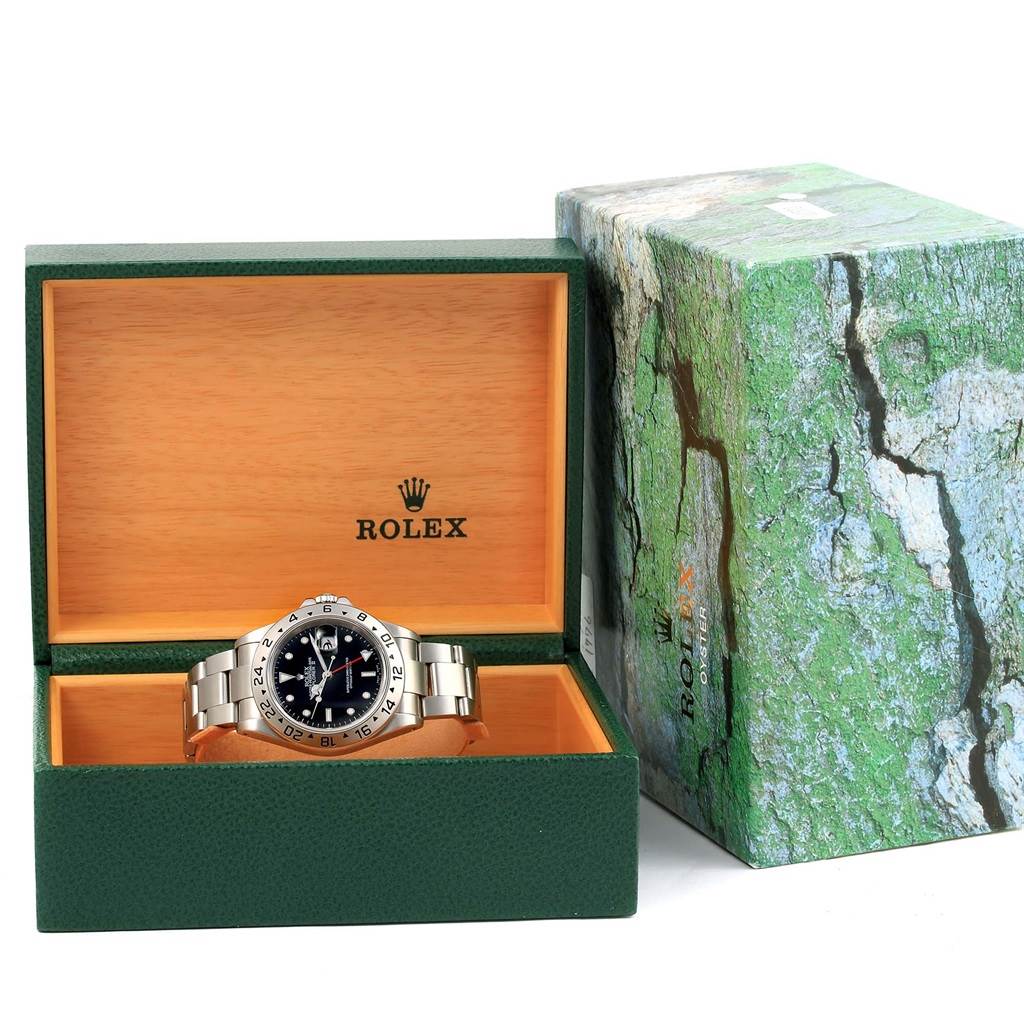 The Rolex Explorer 16570 Men's Stainless Steel Black Dial 16570 Men's Stainless Steel Black Dial watch is displayed front-on inside its open green and wooden presentation box, with the outer box beside it.