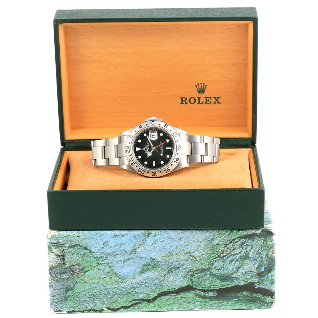 The Rolex Explorer 16570 Men's Stainless Steel Black Dial 16570 Men's Stainless Steel Black Dial watch is shown front-on in its open box, displaying the dial, bezel, bracelet, and crown.