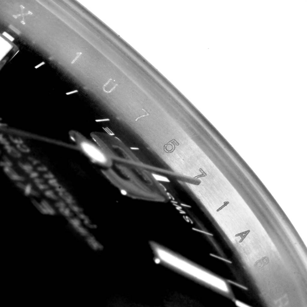 A close-up angled view of the Rolex Explorer 214270 Men's Stainless Steel Black Dial 214270 Men's Stainless Steel Black Dial model showing part of the dial and bezel numbers 5 to 7.