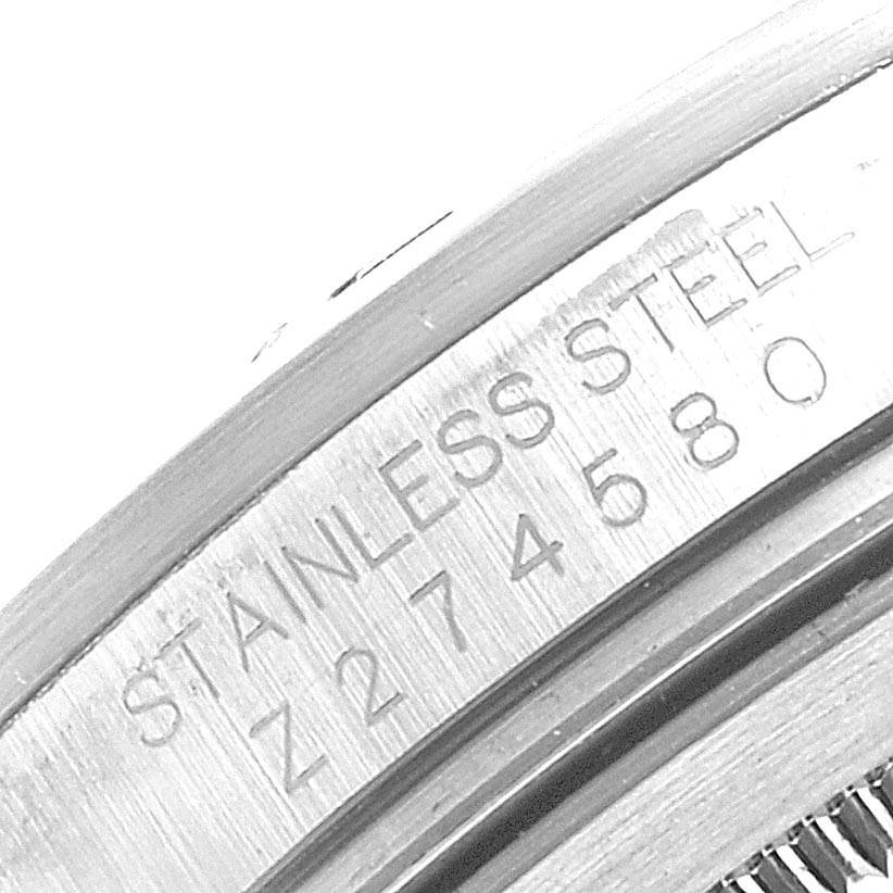 This image shows a close-up, angled view of the side of a Rolex Explorer 16570 Men's Stainless Steel White Dial 16570 Men's Stainless Steel White Dial watch casing, highlighting the "STAINLESS STEEL" and serial number engraving.