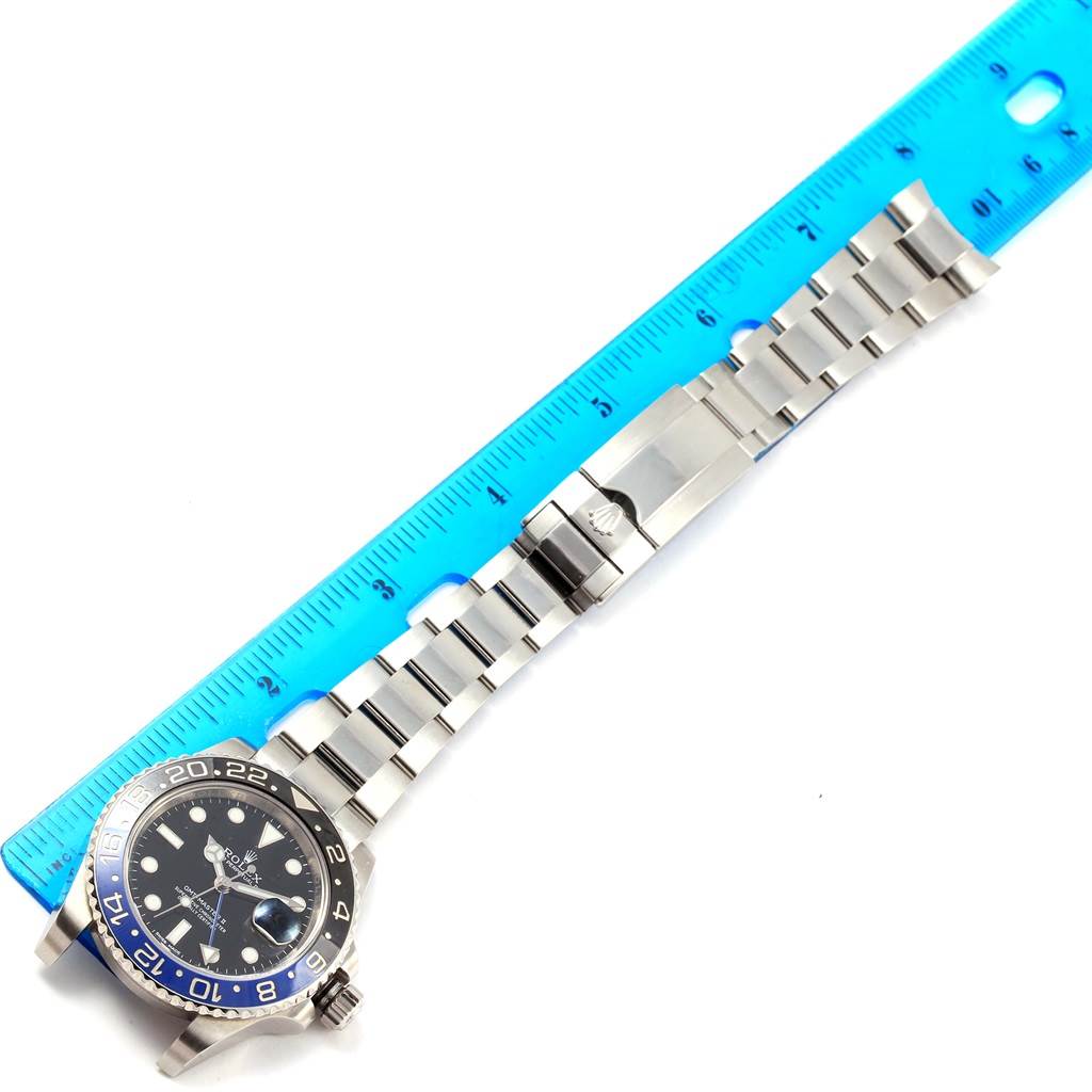 The Rolex GMT-Master 116710 Men's Stainless Steel Black Dial 116710 Men's Stainless Steel Black Dial watch is shown from a top-down angle with a blue ruler indicating its length.