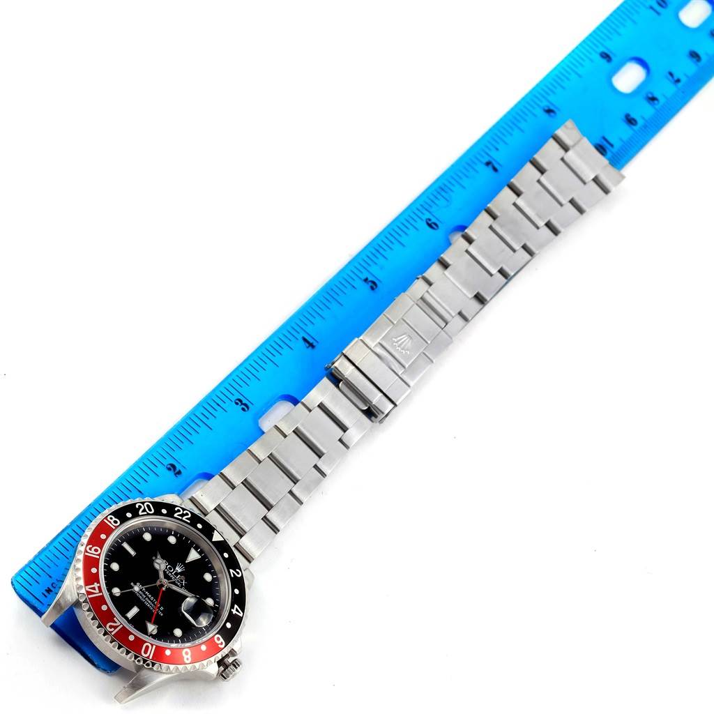 The image shows the Rolex GMT-Master 16710 Men's Stainless Steel Black Dial 16710 Men's Stainless Steel Black Dial watch laid flat with a ruler, displaying the dial, bezel, and bracelet.