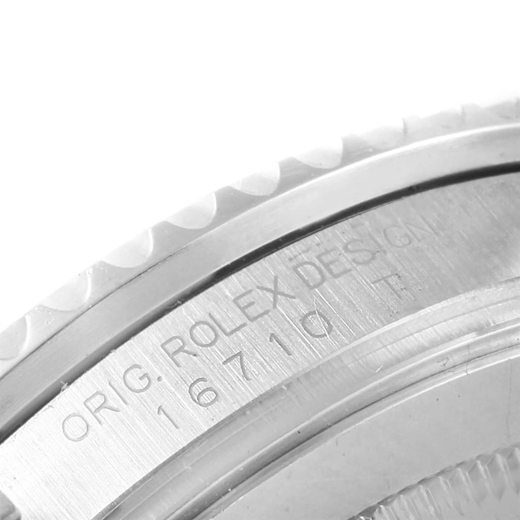 This close-up image shows the engraved side of the bezel and case back of a Rolex GMT-Master 16710 Men's Stainless Steel Black Dial 16710 Men's Stainless Steel Black Dial watch.