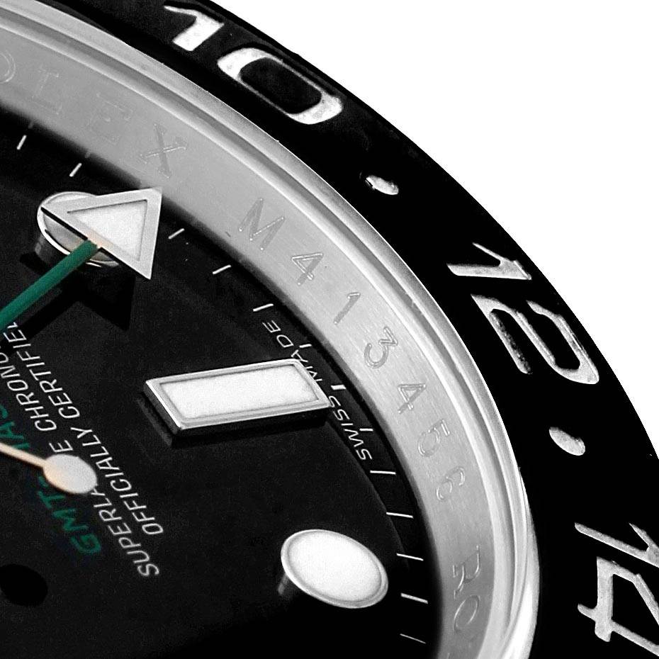 The image shows a close-up of the bezel, part of the dial, and hands of a Rolex GMT-Master 116710 Men's Stainless Steel Black Dial 116710 Men's Stainless Steel Black Dial watch.