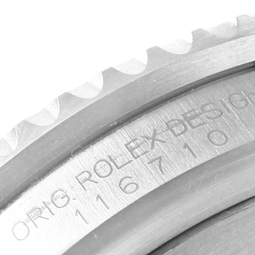 The image shows a close-up of the edge and engraved serial number of a Rolex GMT-Master 116710 Men's Stainless Steel Black Dial 116710 Men's Stainless Steel Black Dial watch bezel.