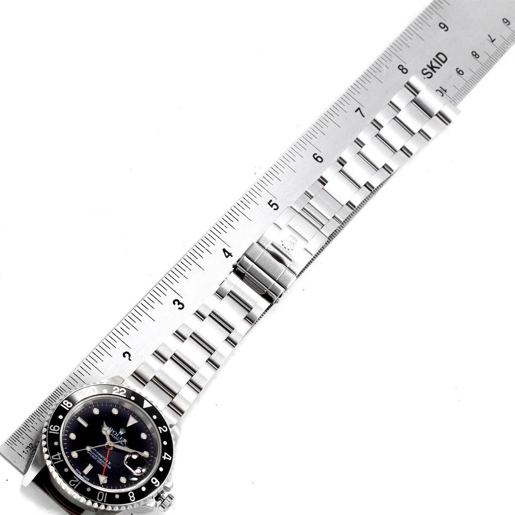 The image shows part of the dial and the full bracelet of a Rolex GMT-Master 16710 Men's Stainless Steel Black Dial 16710 Men's Stainless Steel Black Dial watch, aligned with a ruler for measurement.