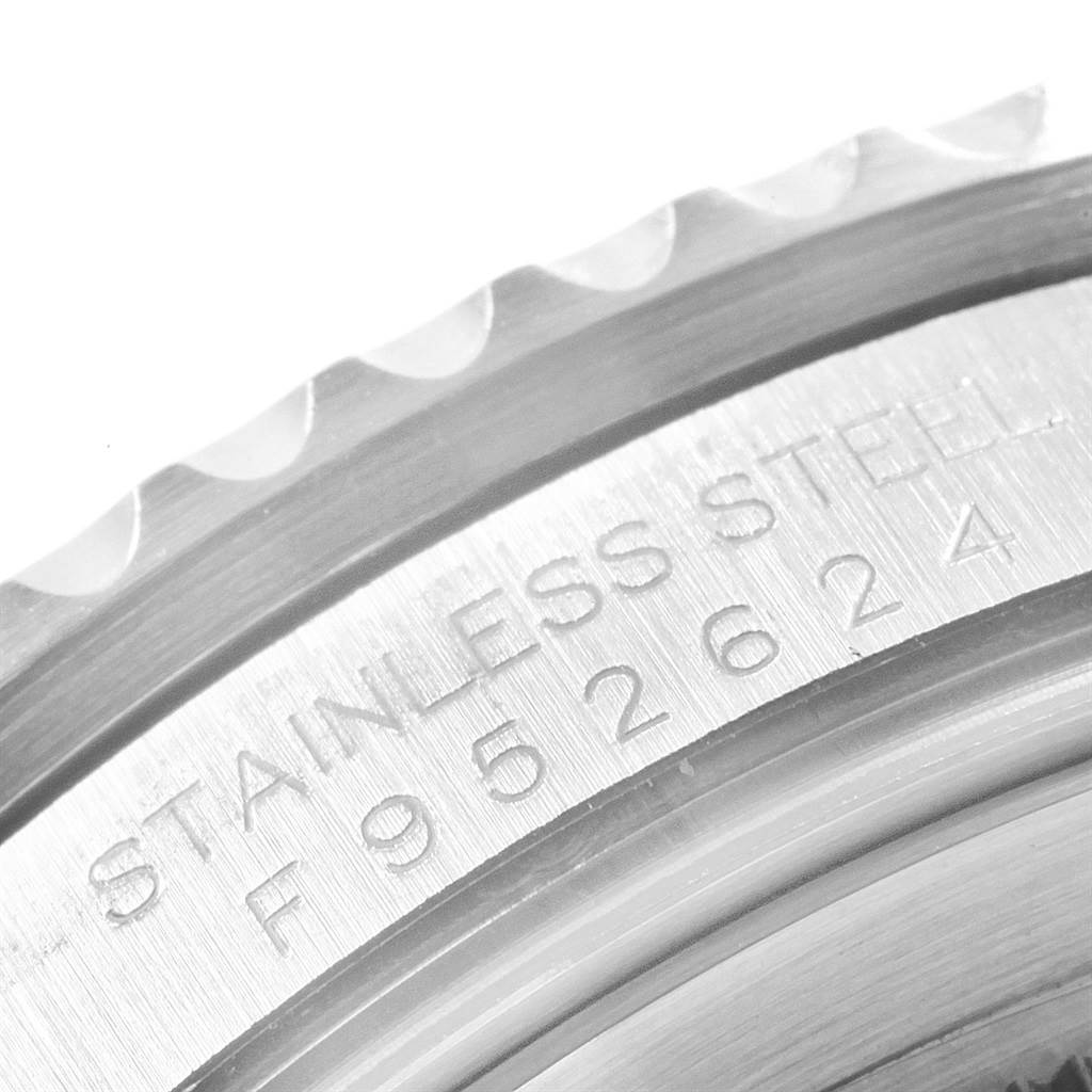 This close-up image of the Rolex GMT-Master 16710 Men's Stainless Steel Black Dial 16710 Men's Stainless Steel Black Dial watch shows the engraved stainless steel case and part of the serrated bezel.