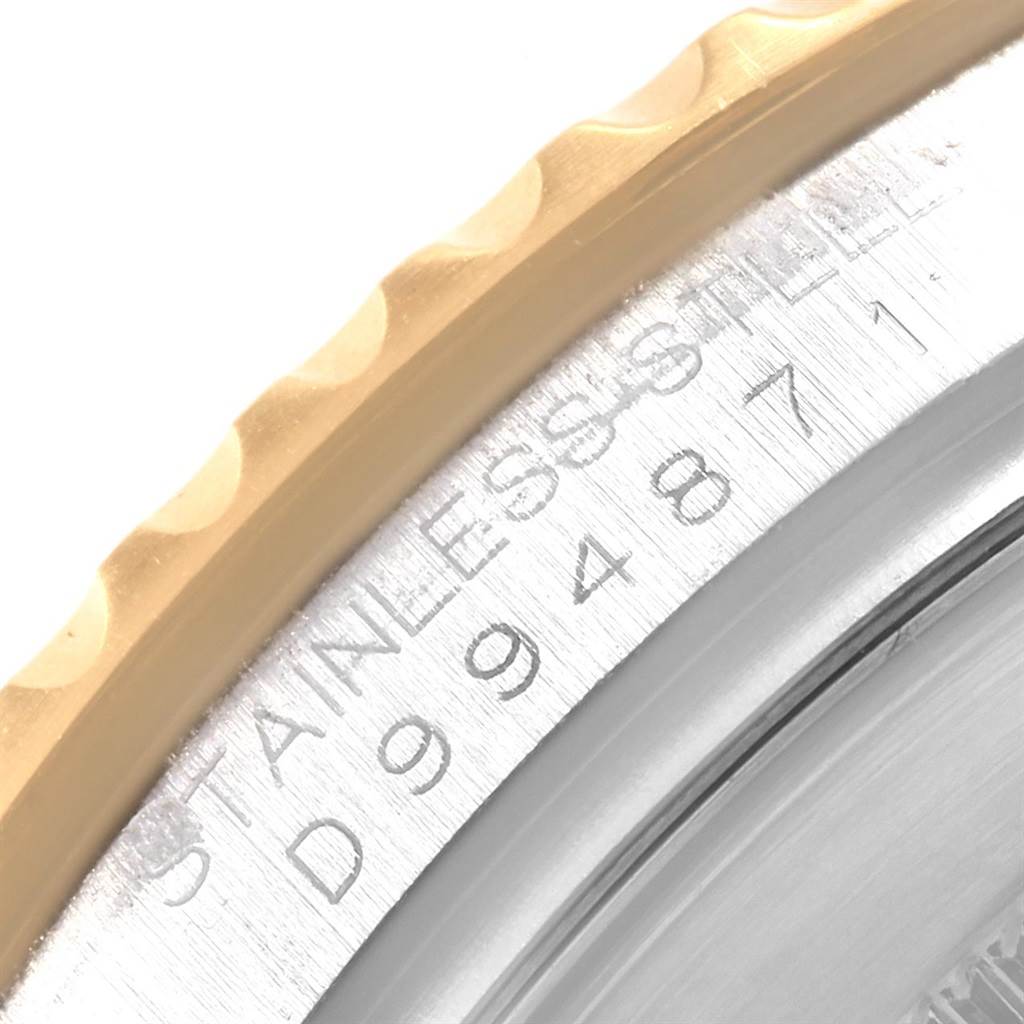 The image shows a close-up of the bezel and case-back of a Rolex Yacht-Master 16623 Men's Stainless Steel White Dial 16623 Men's Stainless Steel White Dial watch, highlighting the serial number and "STAINLESS STEEL" engraving.