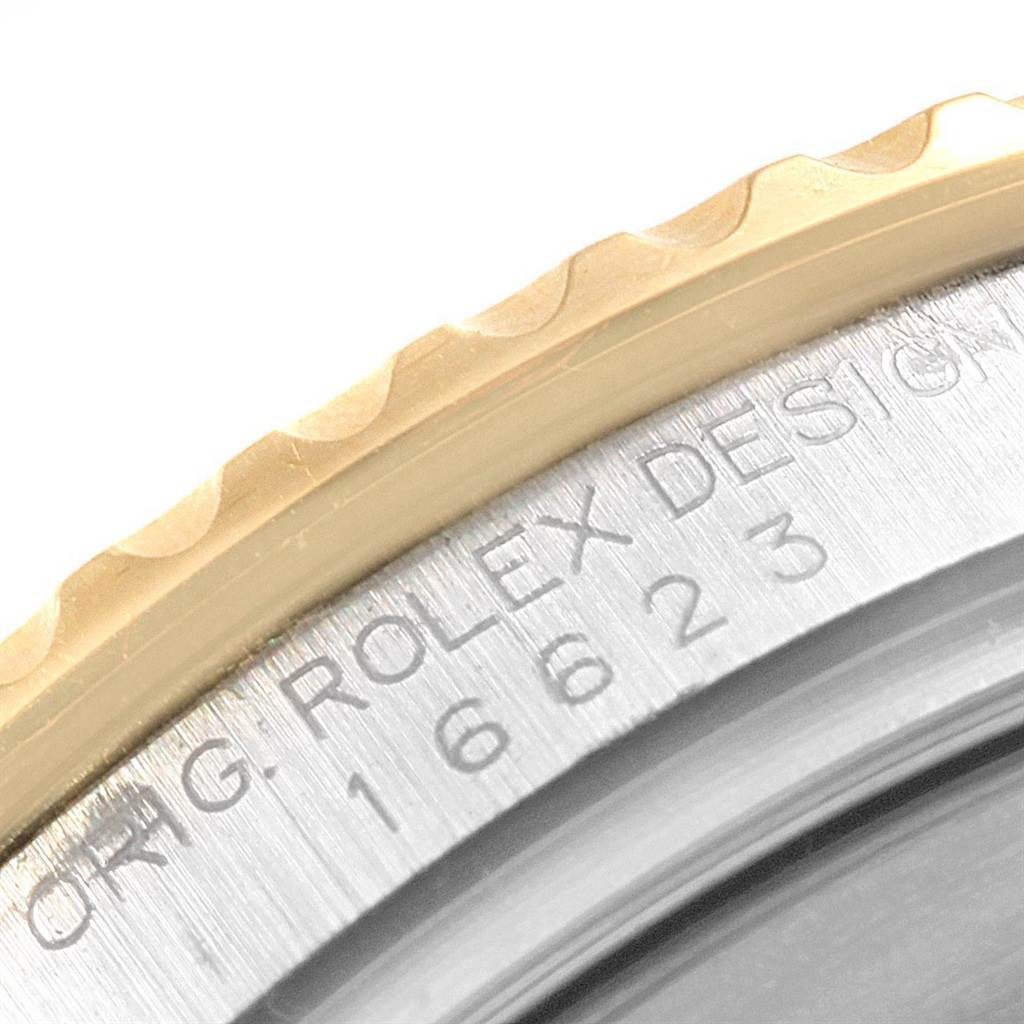 The image shows a close-up of the bezel and case side of a Rolex Yacht-Master 16623 Men's Stainless Steel White Dial 16623 Men's Stainless Steel White Dial, highlighting engravings.