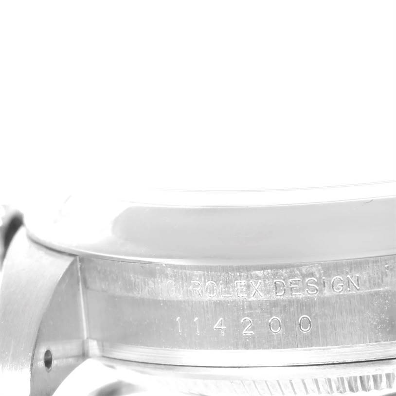 The image shows a close-up of the side of a Rolex Air-King 114200 Men's Stainless Steel Silver Dial 114200 Men's Stainless Steel Silver Dial watch, highlighting its serial number and "Rolex Design" engraving.