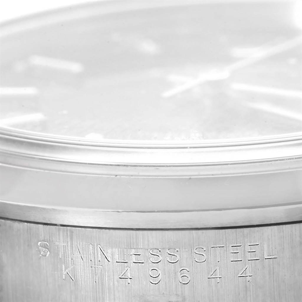 This close-up shows the side of the Rolex Air-King 14000 Men's Stainless Steel Black Dial 14000 Men's Stainless Steel Black Dial watch, focusing on its stainless steel casing and engraved serial number.