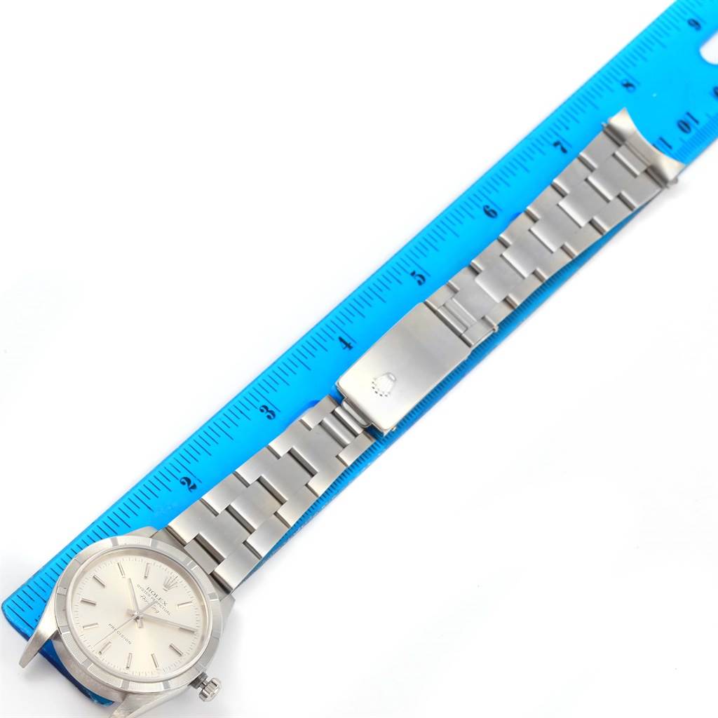 The image shows a Rolex Air-King 14010 Men's Stainless Steel Silver Dial 14010 Men's Stainless Steel Silver Dial watch laid flat alongside a ruler, displaying its face and metal bracelet.