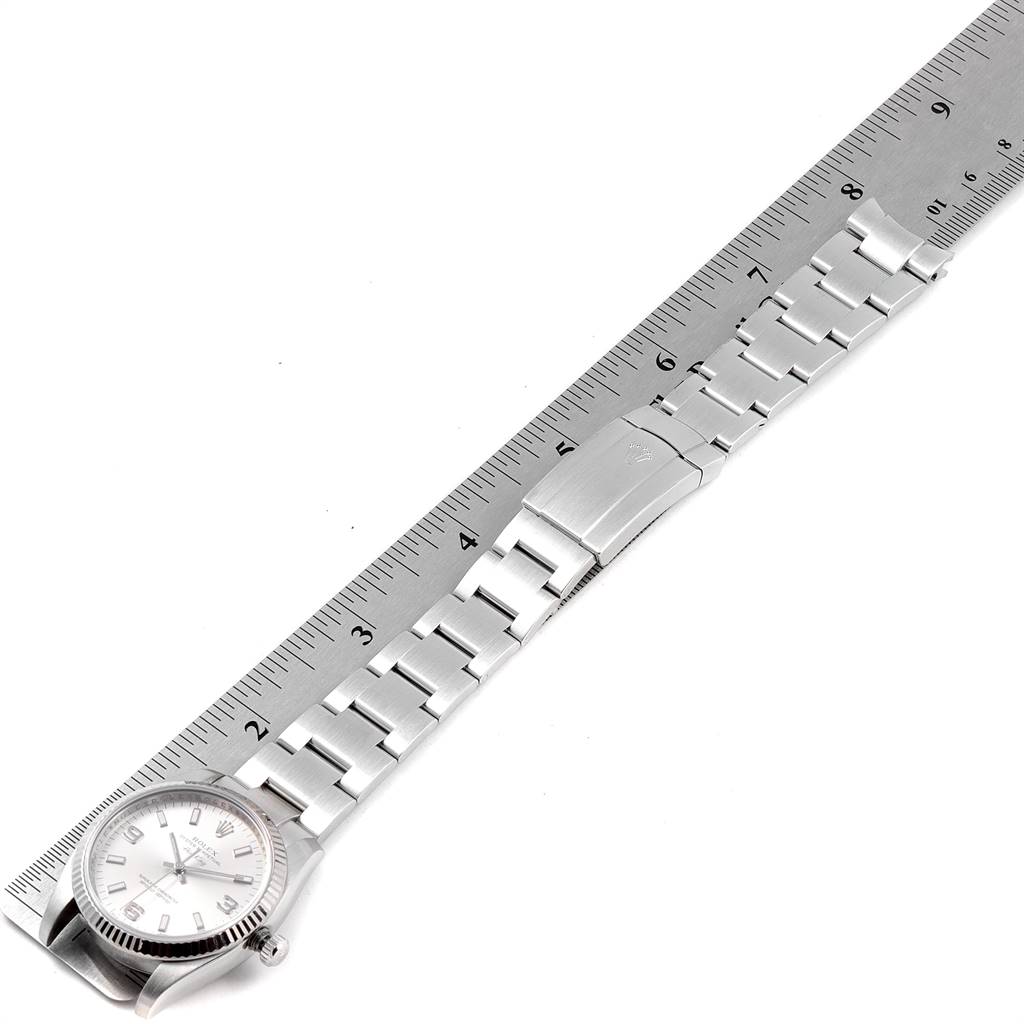 The image shows a Rolex Air-King 114234 Men's Stainless Steel Silver Dial 114234 Men's Stainless Steel Silver Dial watch laid flat alongside a ruler, highlighting its bracelet and clasp.