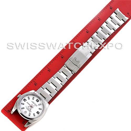 This image shows a top-down view of a Rolex Air-King 114200 Men's Stainless Steel White Dial 114200 Men's Stainless Steel White Dial watch, fully extended next to a red ruler.