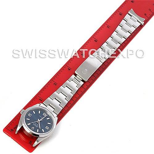 This Air-King model by Rolex is shown horizontally, displaying the watch face, bracelet, and clasp alongside a red ruler.