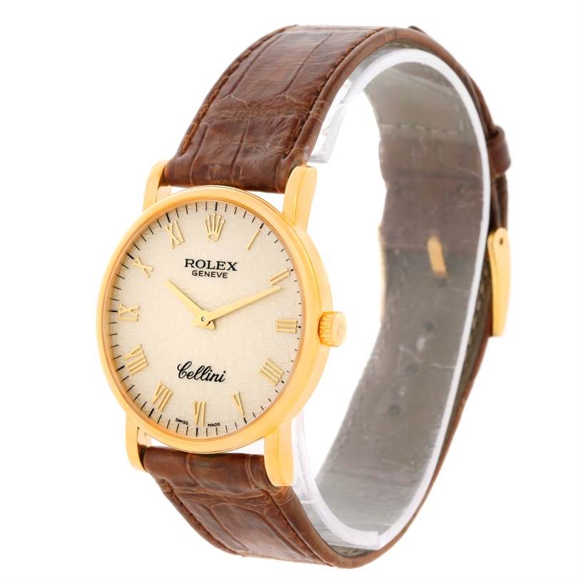 The Rolex Cellini 5115 Men's Yellow Gold Beige Dial 5115 Men's Yellow Gold Beige Dial watch is shown at a slight side angle, highlighting the face, bezel, crown, and brown leather strap.