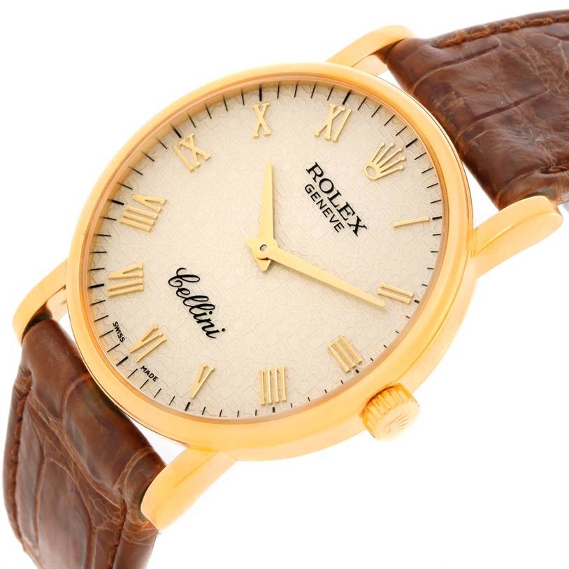 The image shows a close-up view of the Rolex Cellini 5115 Men's Yellow Gold Beige Dial 5115 Men's Yellow Gold Beige Dial watch's face, case, crown, and leather strap at an angle.