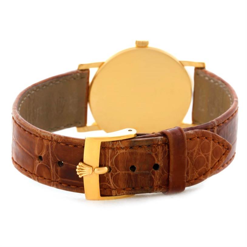 The image shows the back view of a Rolex Cellini 5115 Men's Yellow Gold Beige Dial 5115 Men's Yellow Gold Beige Dial watch, highlighting the brown leather strap and gold buckle.