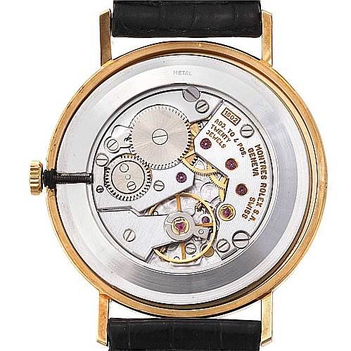 The image displays the back view of a Rolex Cellini 4112 Yellow Gold Champagne Dial 4112 Yellow Gold Champagne Dial watch, showcasing its internal mechanical movement.