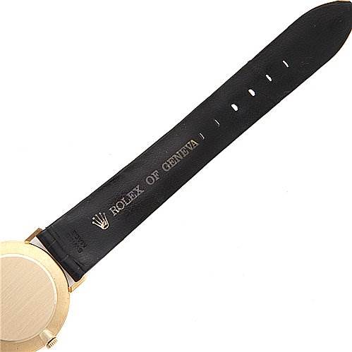 This image shows the back of the Rolex Cellini 4112 Yellow Gold Champagne Dial 4112 Yellow Gold Champagne Dial watch and part of its black leather strap with the "Rolex of Geneva" inscription.