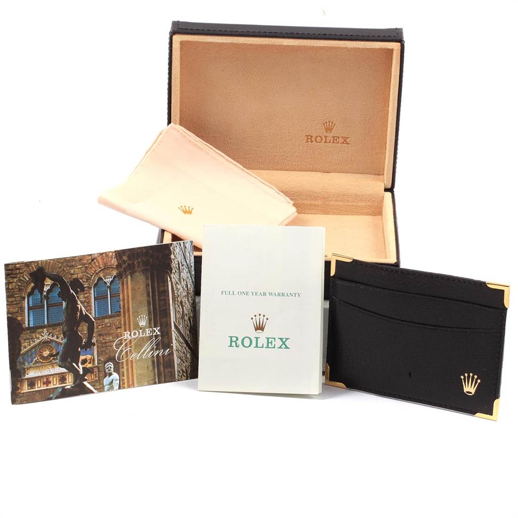 The image shows accessories for a Rolex Cellini 5112 Men's Yellow Gold Beige Dial 5112 Men's Yellow Gold Beige Dial watch, including a box, cleaning cloth, manual, warranty card, and a cardholder.