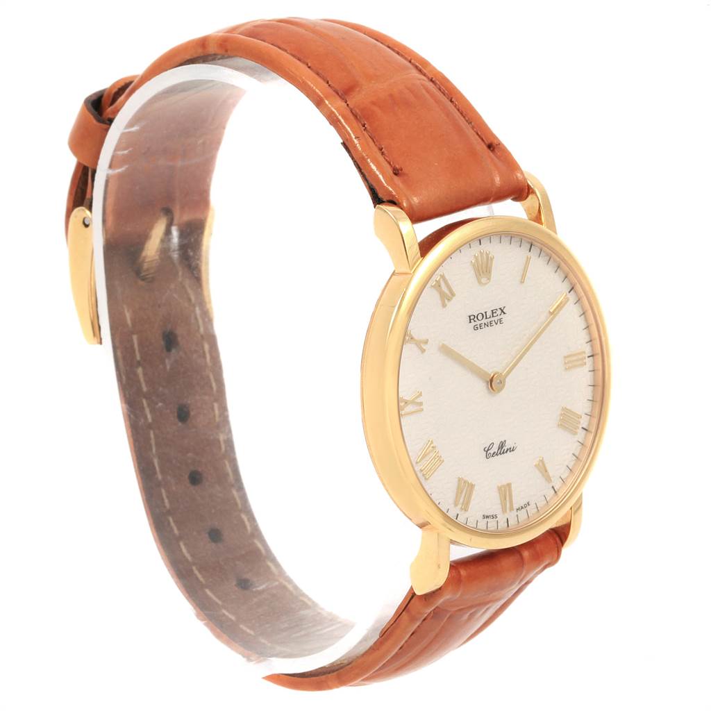 The image shows a side view of a Rolex Cellini 5112 Men's Yellow Gold Beige Dial 5112 Men's Yellow Gold Beige Dial watch with a brown leather strap and a gold case.