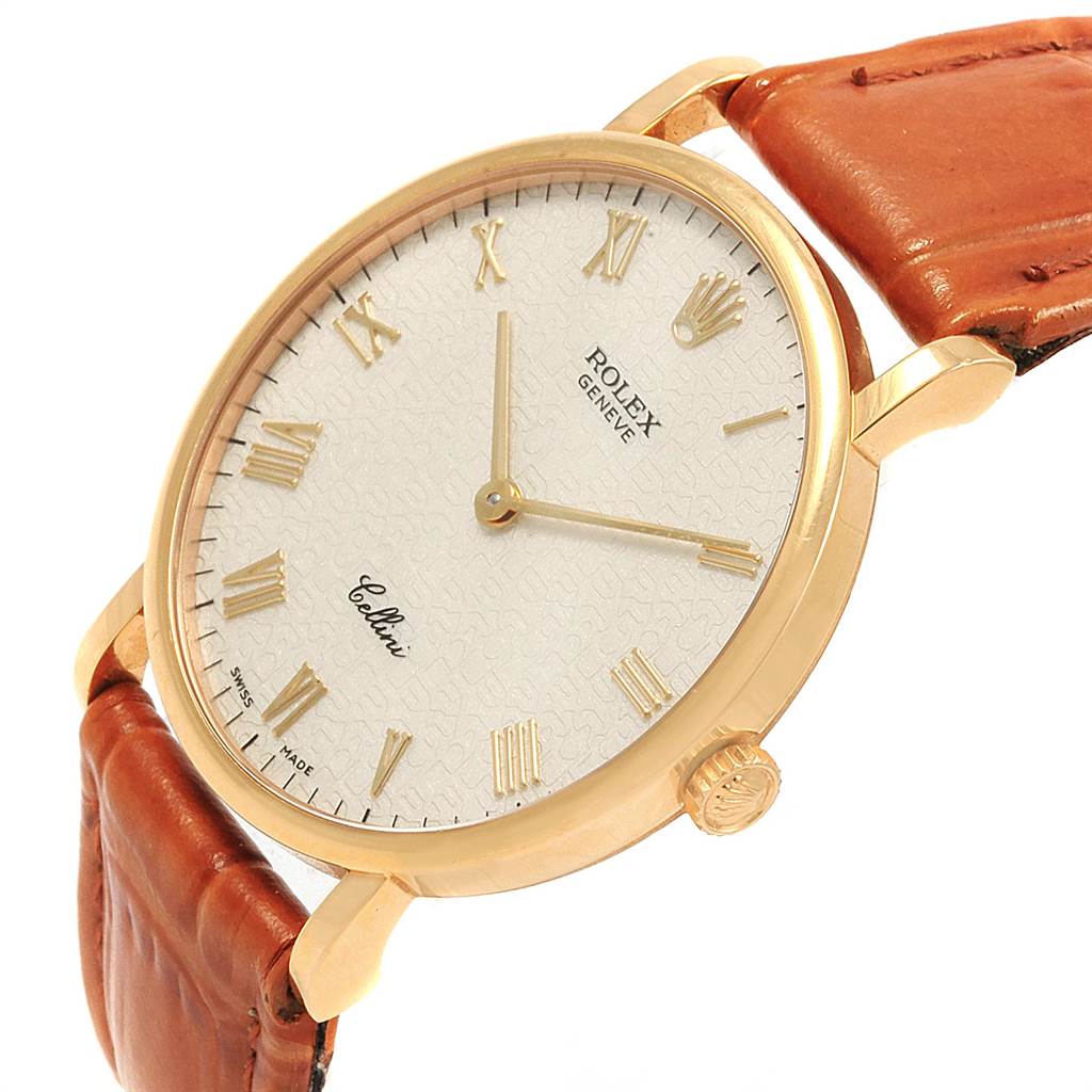 This Rolex Cellini 5112 Men's Yellow Gold Beige Dial 5112 Men's Yellow Gold Beige Dial watch is shown at an angled close-up, displaying its white dial, gold indices, case, and brown leather strap.