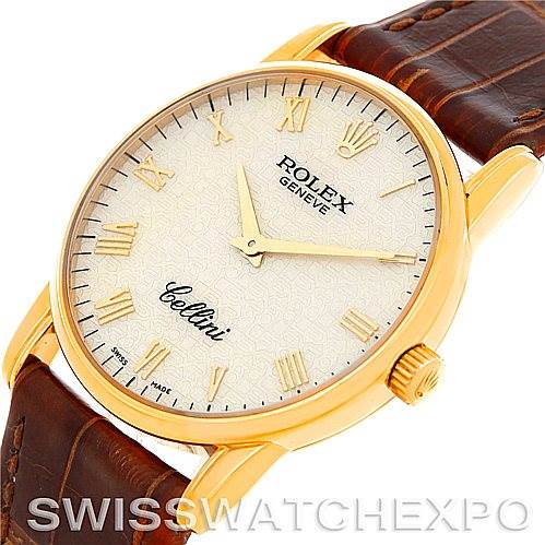 The Rolex Cellini 5116 Men's Yellow Gold Beige Dial 5116 Men's Yellow Gold Beige Dial watch is shown from an angled top view, highlighting its dial, case, crown, and leather strap.