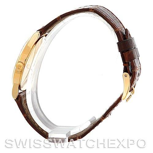 The image shows a side view of the Rolex Cellini 5116 Men's Yellow Gold Beige Dial 5116 Men's Yellow Gold Beige Dial model focusing on its brown leather strap and gold buckle.