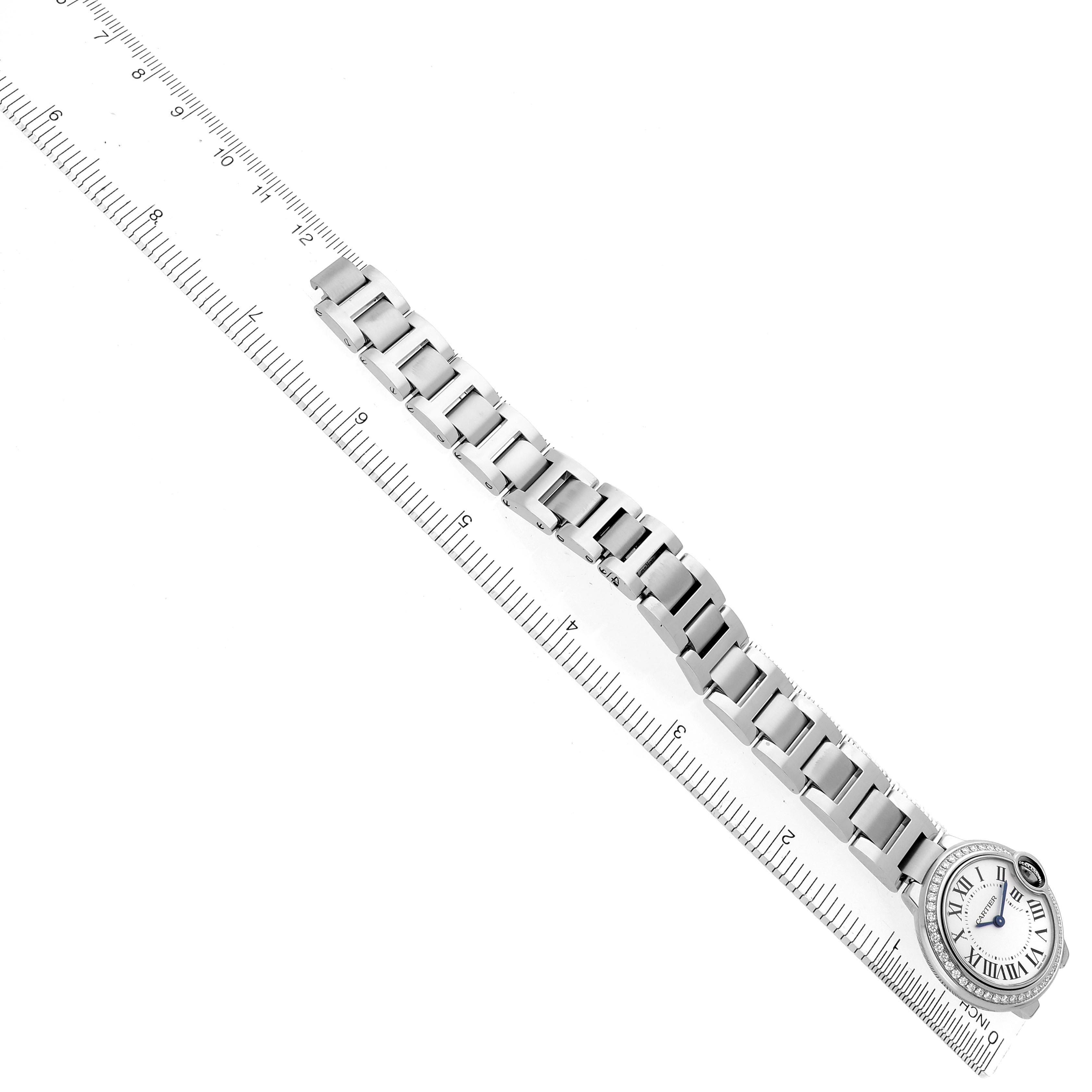 The Cartier Ballon Bleu W4BB0015 Women's Stainless Steel Silver Dial W4BB0015 Women's Stainless Steel Silver Dial watch is shown from a top view, displaying the entire bracelet and the face, positioned alongside a ruler.