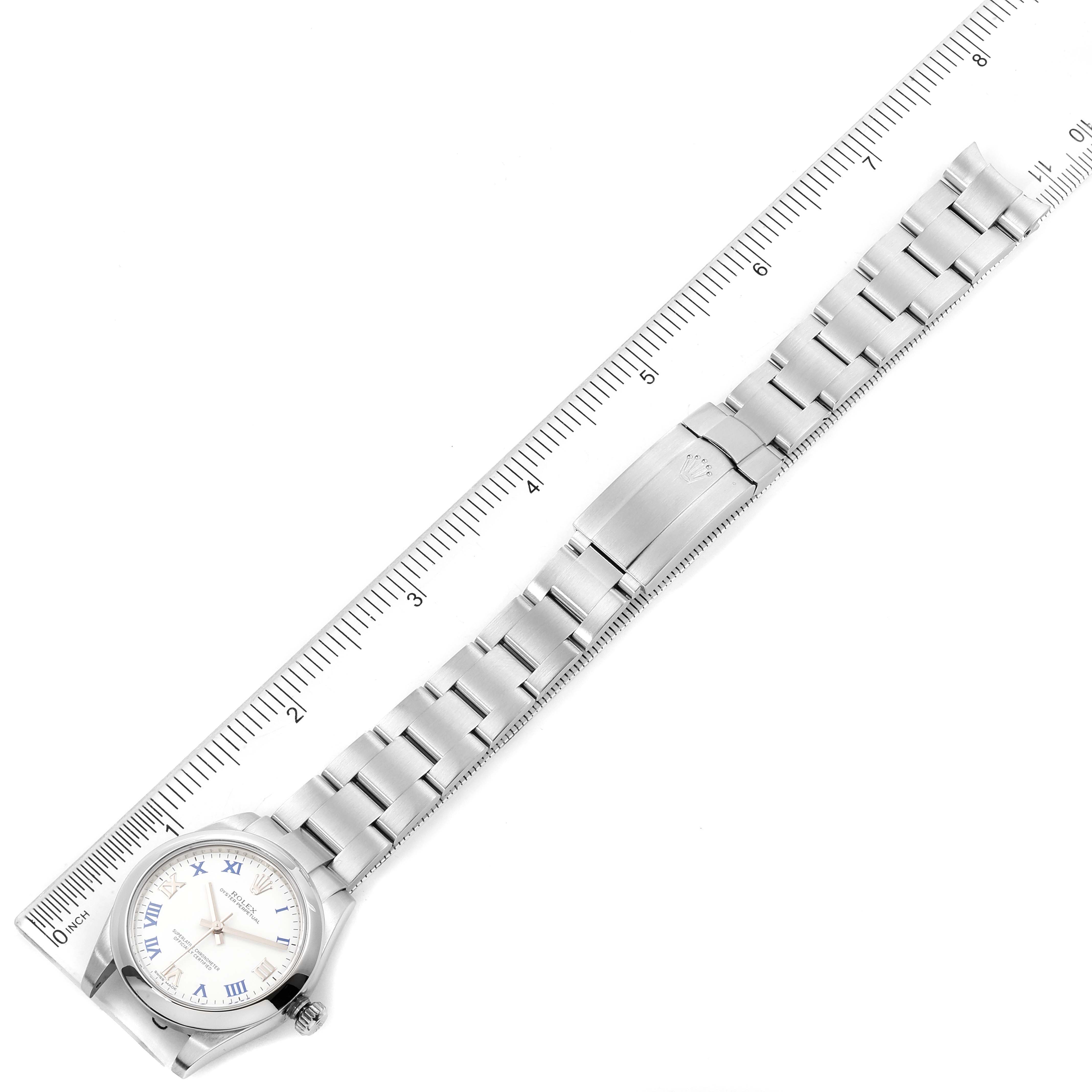 This image shows a Rolex Mid-Size 177200 Women's Stainless Steel White Dial 177200 Women's Stainless Steel White Dial watch laid flat next to a ruler, highlighting the entire bracelet and clasp.
