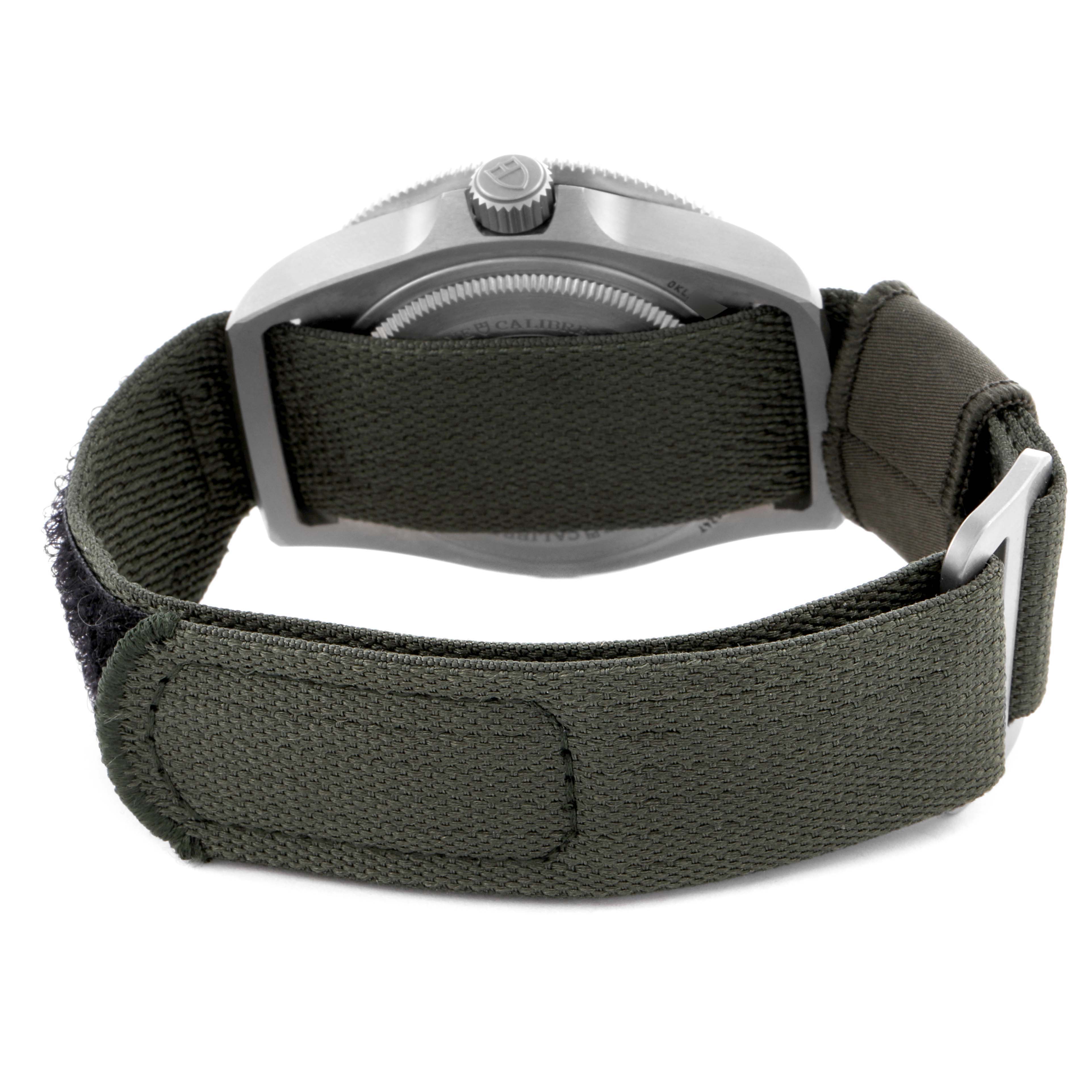 The image shows the back view of a Tudor Pelagos 2542G247NU-0001 Men's Titanium Black Dial 2542G247NU-0001 Men's Titanium Black Dial watch with a green fabric strap and visible buckle.