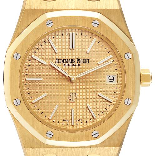 The image shows a close-up of the dial and bezel of the Audemars Piguet Royal Oak 15202BA Men's Yellow Gold Champagne Dial 15202BA Men's Yellow Gold Champagne Dial watch, highlighting its gold finish and date window at 3 o'clock.