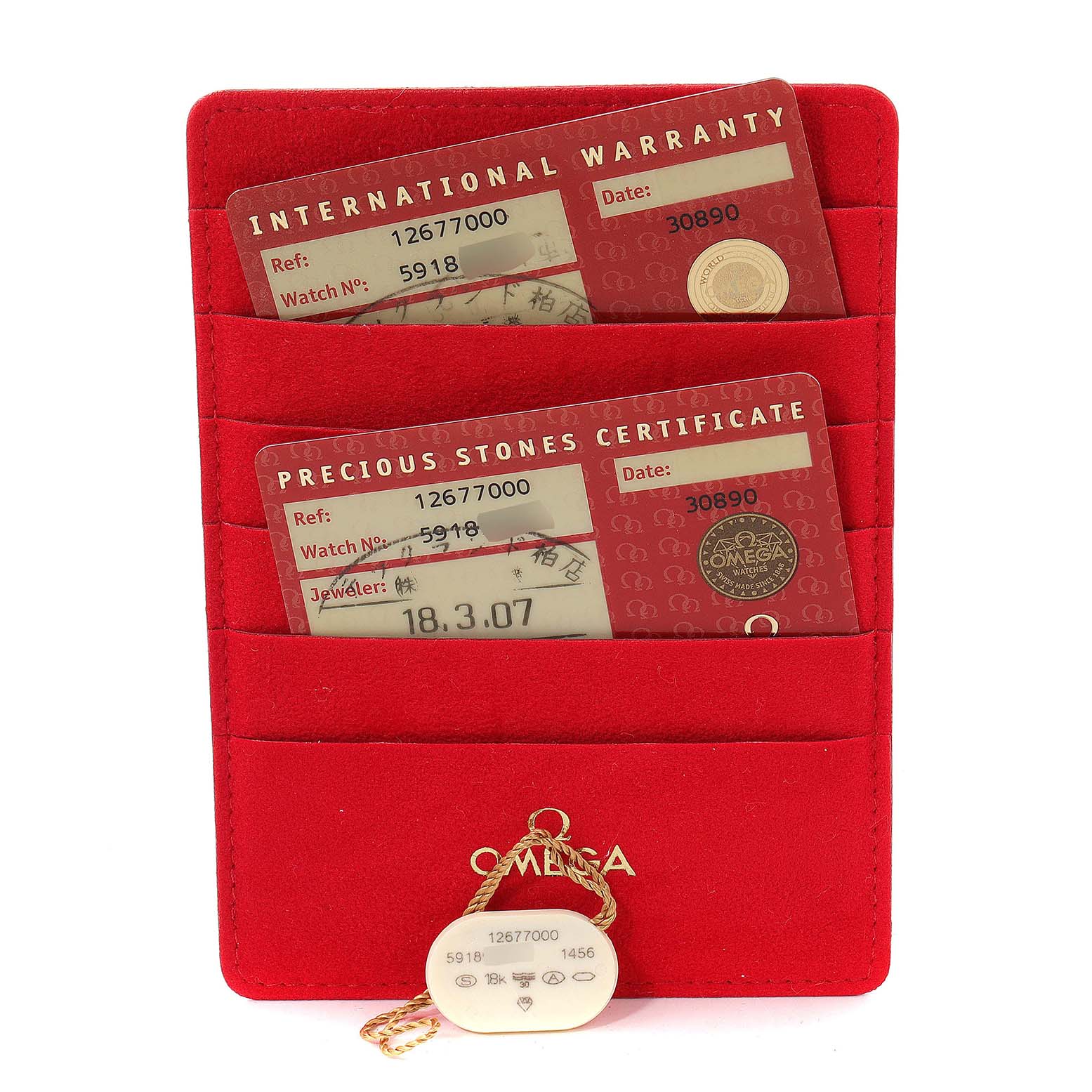 This image shows the warranty cards and a tag for the Omega 1267.70.00 Women's Steel and Gold (two tone) Mother of Pearl Dial 1267.70.00 Women's Steel and Gold (two tone) Mother of Pearl Dial Constellation Steel Yellow Gold MOP Diamond Watch model 1267.70.00.