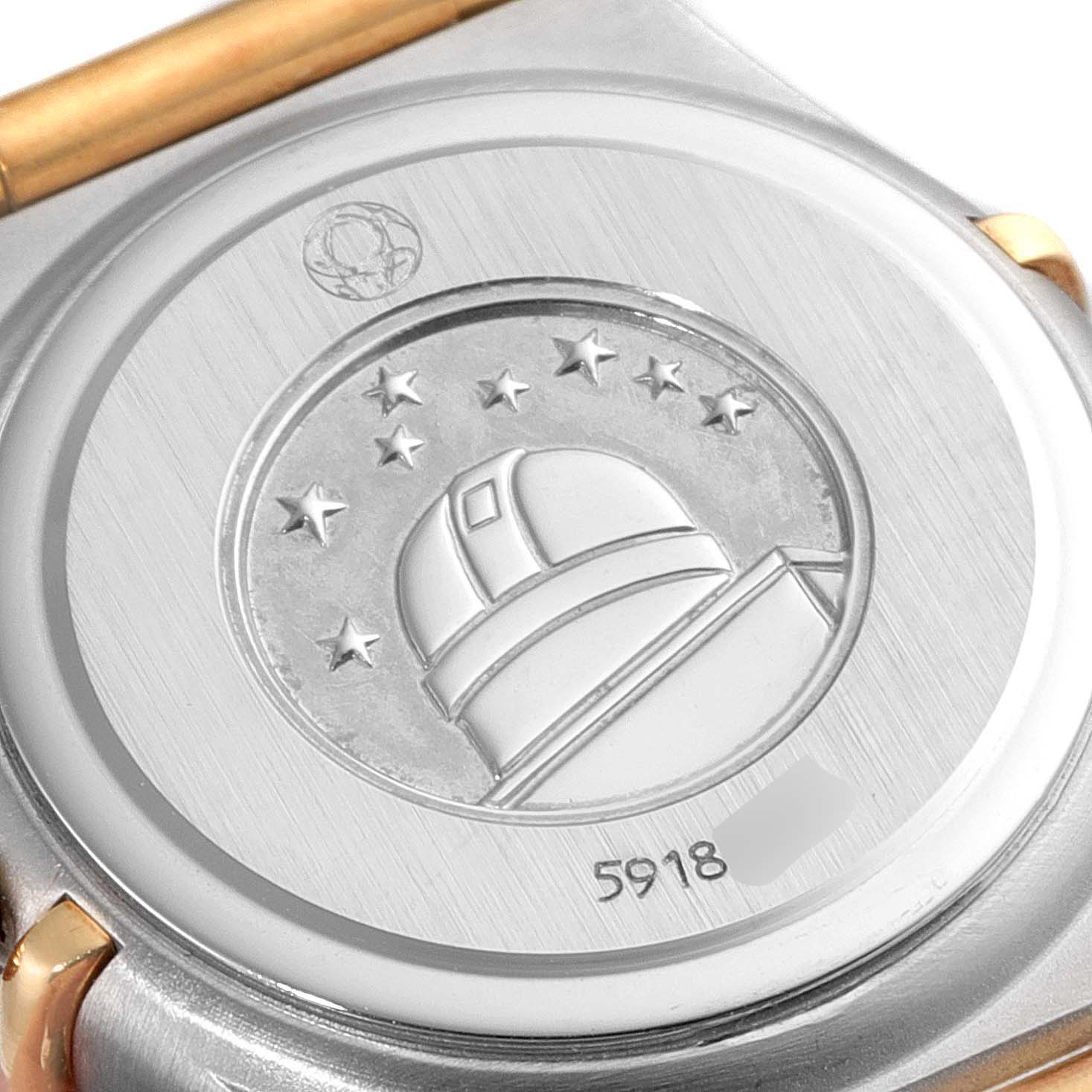 This image shows the case back of an Omega 1267.70.00 Women's Steel and Gold (two tone) Mother of Pearl Dial 1267.70.00 Women's Steel and Gold (two tone) Mother of Pearl Dial Constellation Steel Yellow Gold MOP Diamond Watch 1267.70.00 with an observatory engraving.