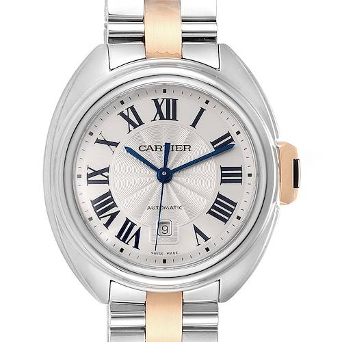The Cle de Cartier watch in this image is shown from a front angle, displaying its face, Roman numerals, and part of its bracelet.