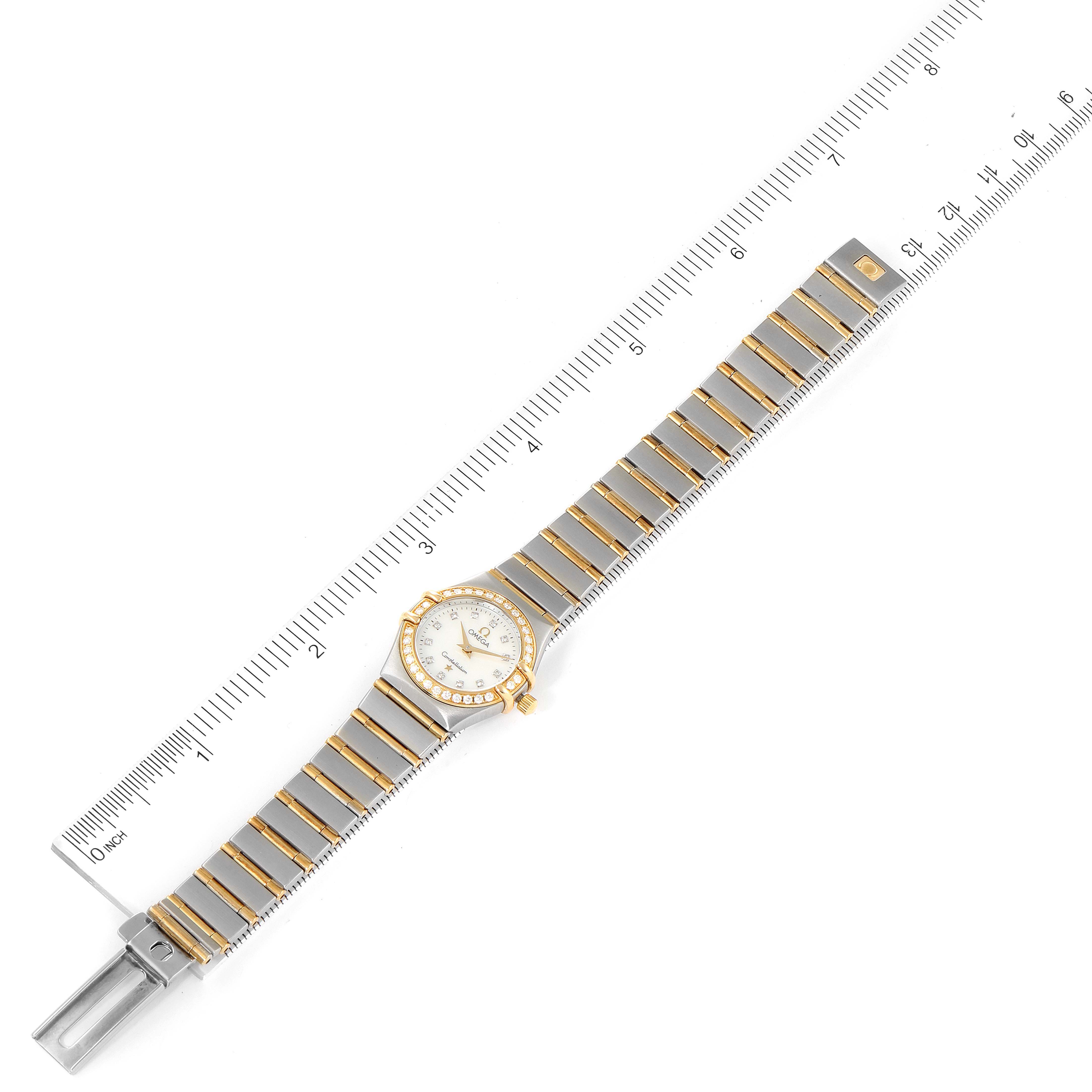 The image shows an overhead view of the Omega 1267.75.00 Women's Steel and Gold (two tone) Mother of Pearl Dial 1267.75.00 Women's Steel and Gold (two tone) Mother of Pearl Dial Constellation 95 Mother of Pearl Diamond Ladies Watch 1267.75.00 model next to a ruler.