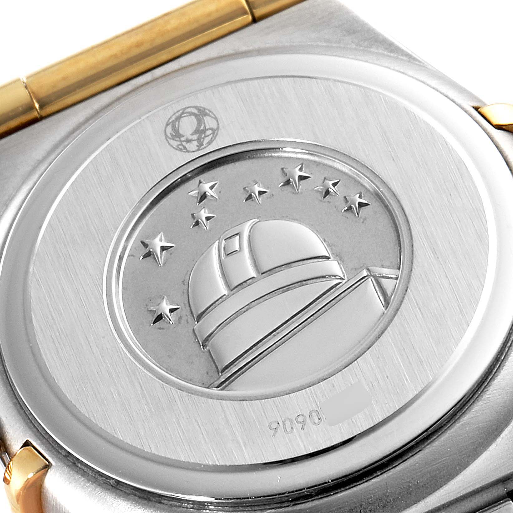 This image shows the case back of the Omega 1267.75.00 Women's Steel and Gold (two tone) Mother of Pearl Dial 1267.75.00 Women's Steel and Gold (two tone) Mother of Pearl Dial Constellation 95 Mother of Pearl Diamond Ladies Watch 1267.75.00, featuring an embossed observatory design.