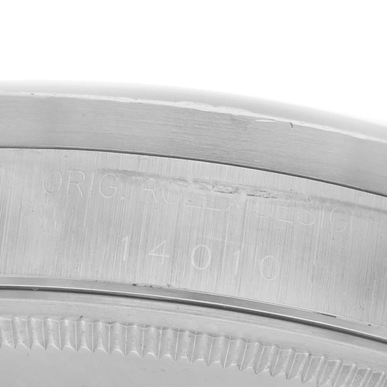 The image shows a close-up of the side engraving on the bezel of a Rolex Air-King 14010 Men's Stainless Steel Silver Dial 14010 Men's Stainless Steel Silver Dial watch.