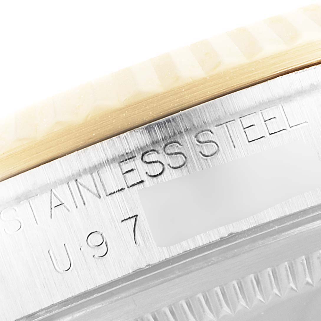 The image shows a close-up of the stainless steel case and part of the bezel of a Rolex Datejust 16233 Men's Steel and Gold (two tone) Grey Dial 16233 Men's Steel and Gold (two tone) Grey Dial watch.