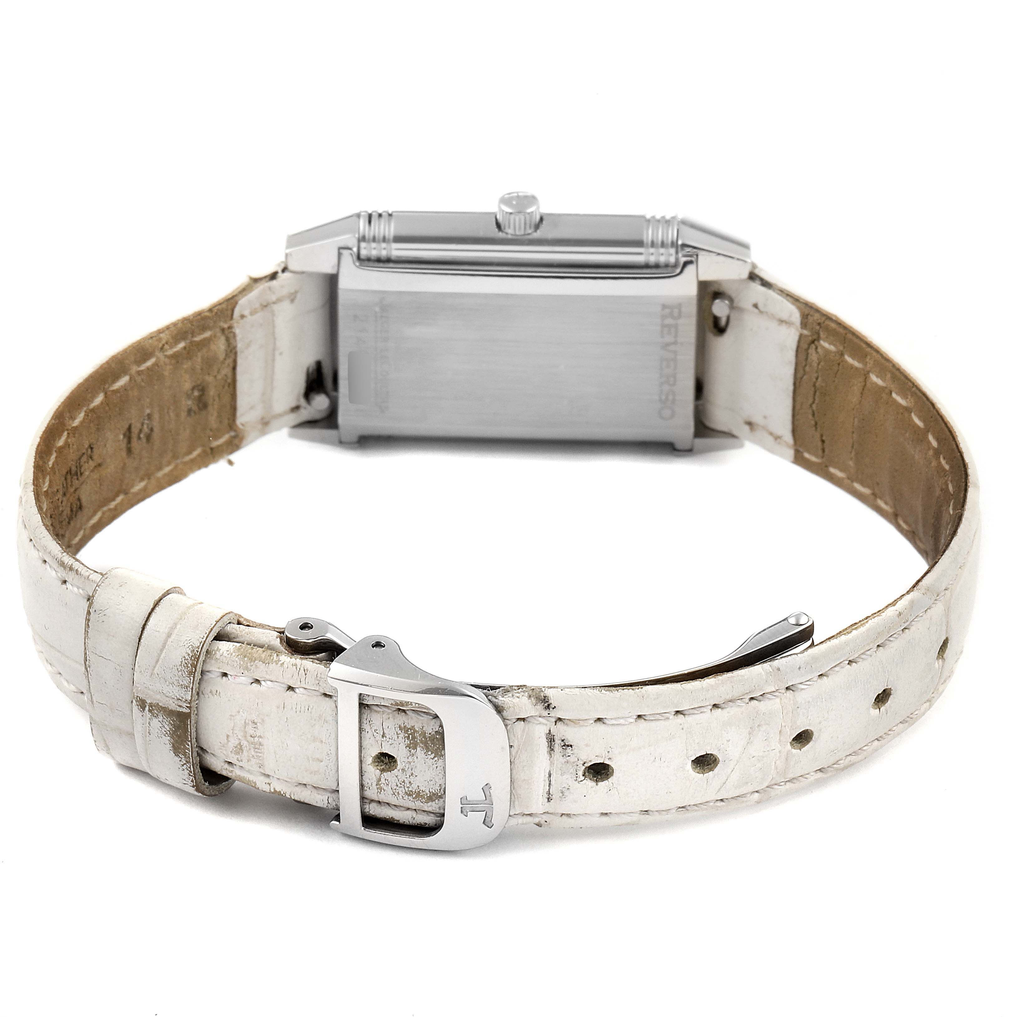 This image shows the back of a Jaeger-LeCoultre Reverso watch, highlighting the case, crown, and white leather strap.