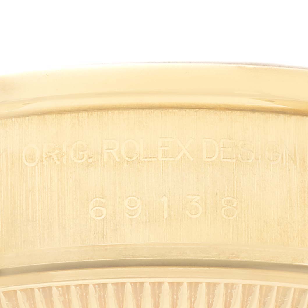 The image shows a close-up of the internal case back engraving of a Rolex President 69138 Women's Yellow Gold Black Dial 69138 Women's Yellow Gold Black Dial model.